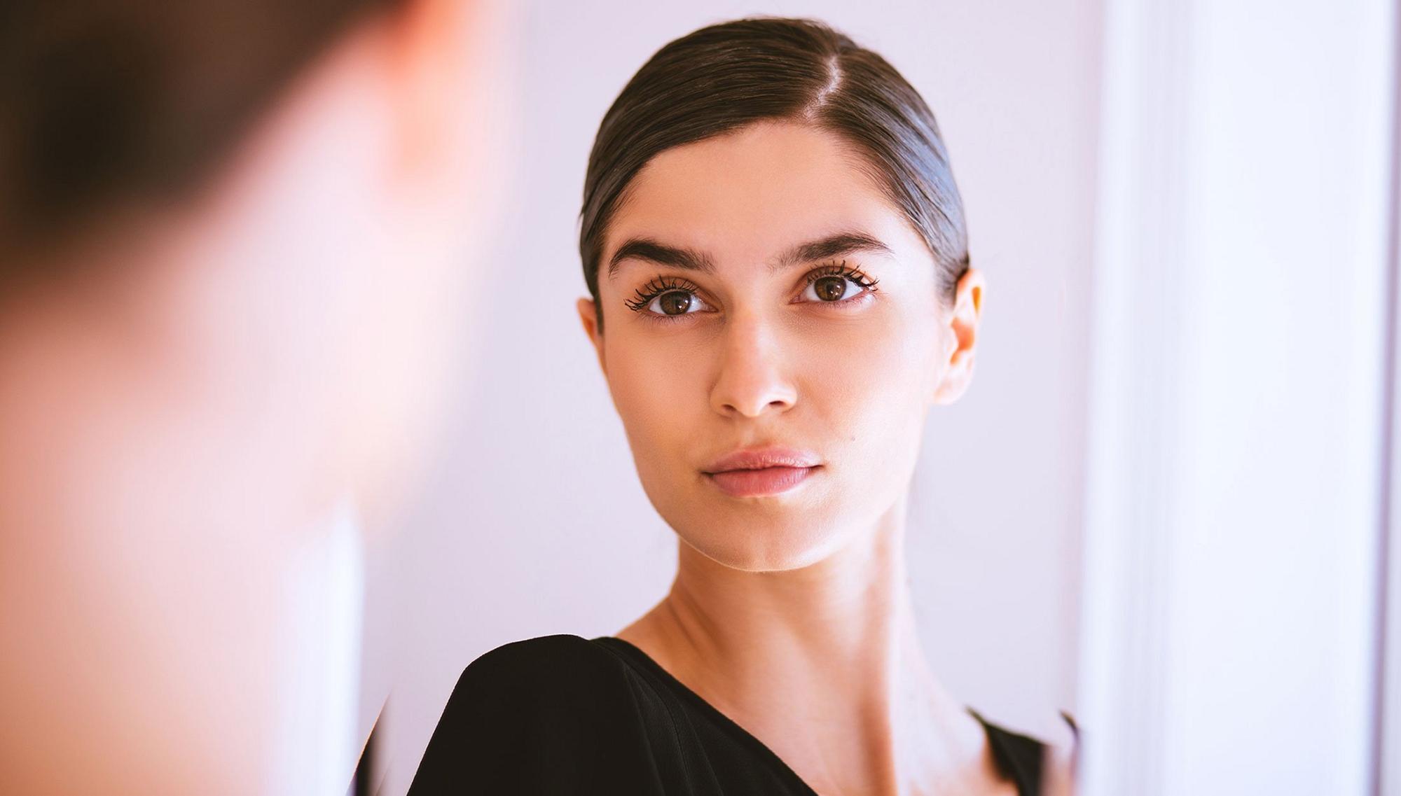 chemical peels patient model looking into a mirror