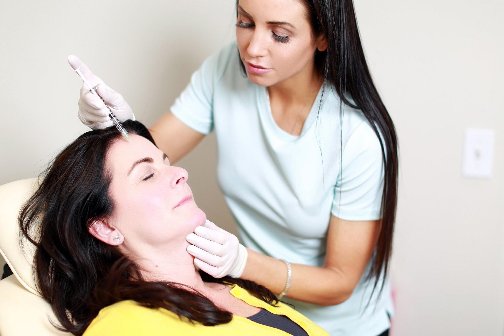 dysport treatment patient model laying back in chair receiving treatment